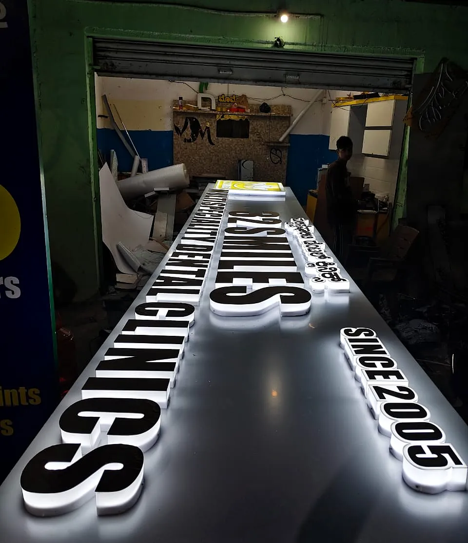 32 Smiles Dental Clinics letters lit up on the workshop table for testing