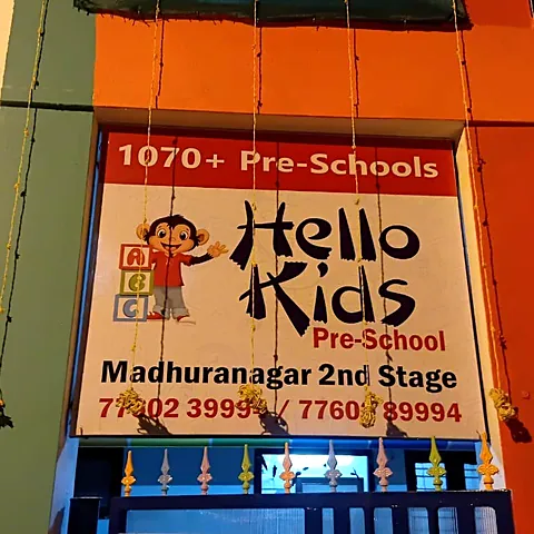 Hello Kids Pre-School board lit at dusk