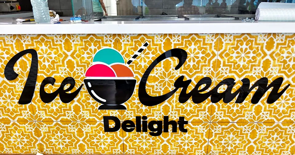 Yellow patterned wall with Ice Cream Delight lettering