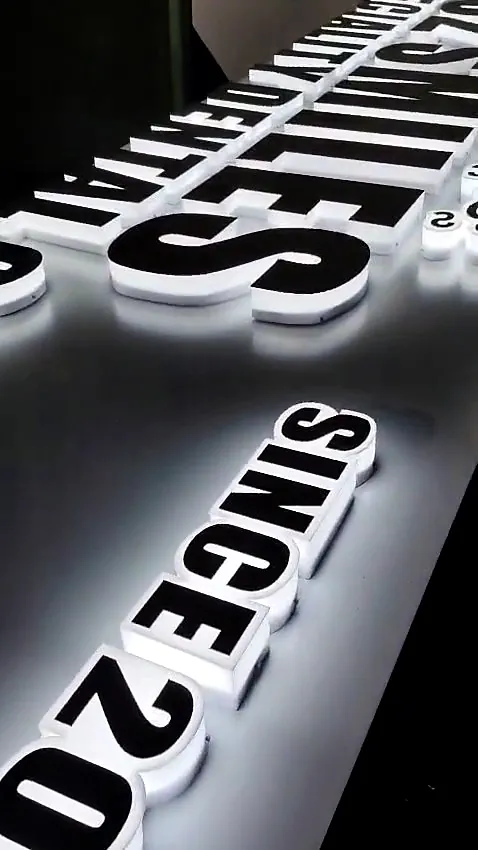Close-up of lit acrylic 3D letters with white returns